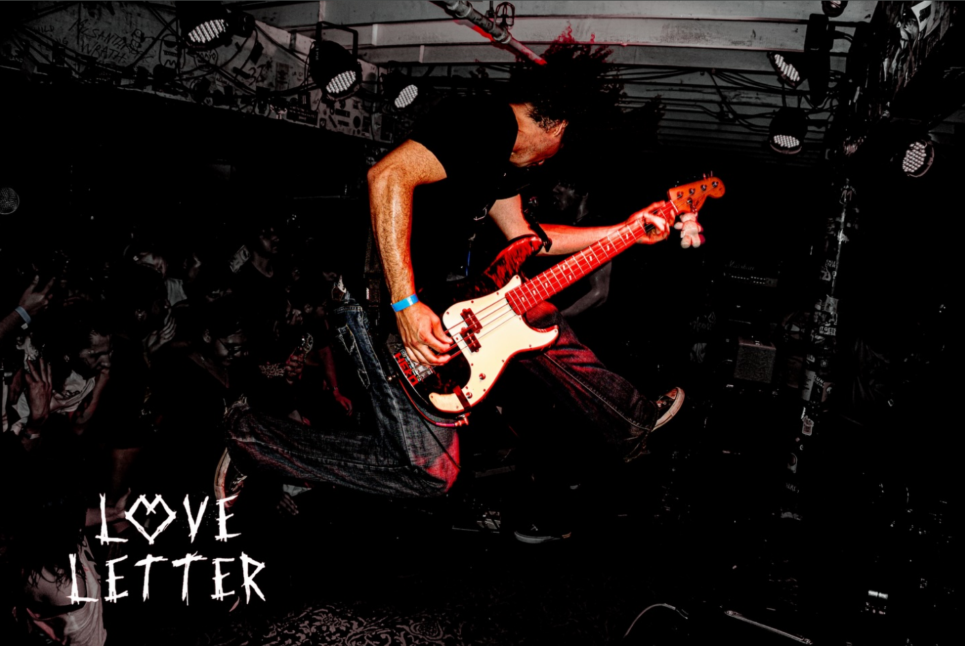 Live punk performance with red stage lighting at an Arizona underground show
